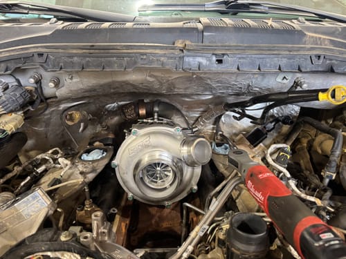 Customer's shiny SPE Strike VGT Stage-1 Turbo newly installed in a truck's engine bay.