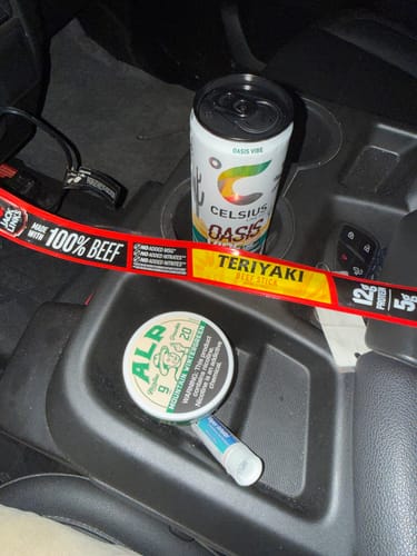 Customer's can of Mountain Wintergreen Nicotine Pouches resting in a truck's center console.