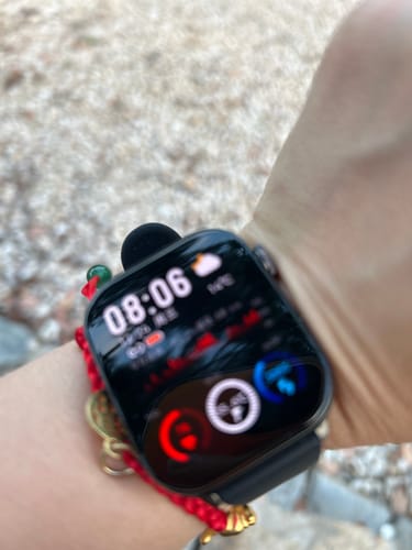 Close-up of a customer's black health smartwatch on their wrist, displaying the digital time and health metrics.