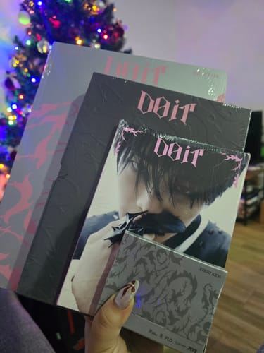 Customer holding several different versions of the STRAY KIDS - DO IT SKZ IT TAPE ALBUM.