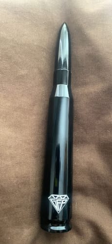 Customer's photo of a glossy black bullet-shaped novelty item with the GFP diamond logo.