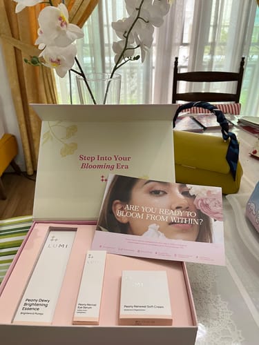Customer's Peony Collection set displayed in an open gift box, showing the Essence, Eye Serum, and Cream.