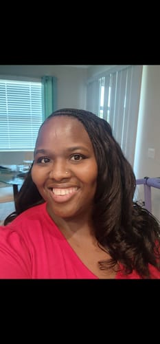 Reviewer smiling, wearing the Human Crochet Hair Body Wave with the ends styled into soft romance curls.