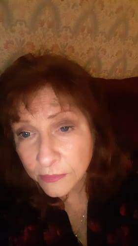 Close-up of a reviewer wearing the Penina Blue Prescription Colored Contact Lenses in a dimly lit setting.