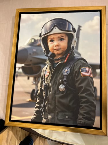 Customer's 'Top Gun Pilot' personalized portrait of a child in a flight suit and helmet, displayed in a gold frame.