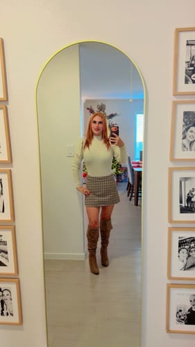 Reviewer showing a full-length view of the taupe Elan Over Knee High Heel Boots with a skirt.