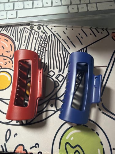 Customer's red and blue cloud clips resting on a patterned desk mat.