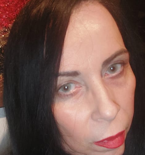 Close-up of a reviewer wearing the light green Emerald contact lenses.