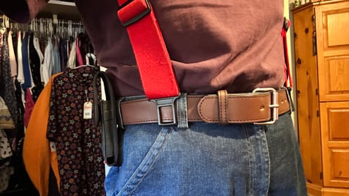 Reviewer wearing the brown Xtreme belt with red suspenders and a tool holster.