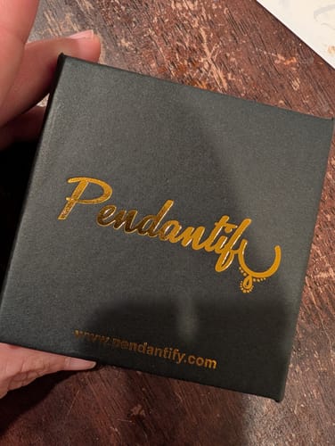 Reviewer holding the black Pendantify gift box for their photo necklace.