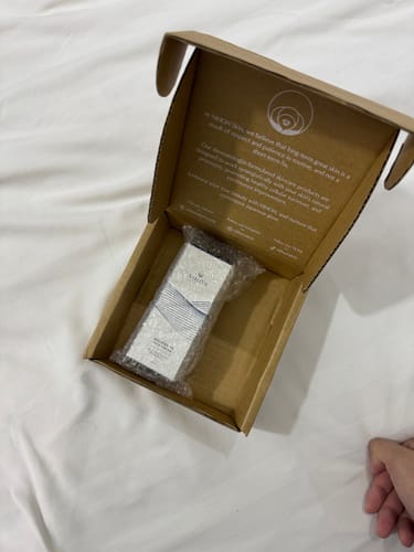 Customer's Brightening Face Crème shown bubble-wrapped inside its open shipping box.