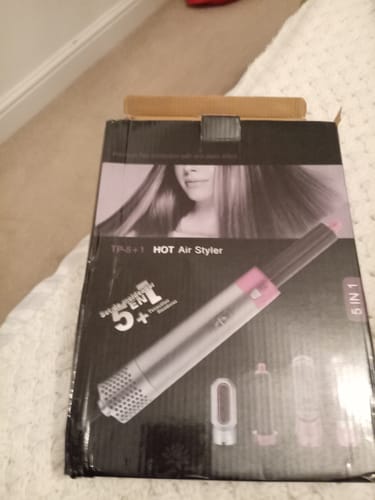 Customer shows the box for a 'HOT Air Styler', stating it's a different product than what was advertised.