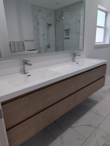 Customer's Monterey Floating Vanity with a wood-grain finish and double sinks, installed in a modern bathroom.
