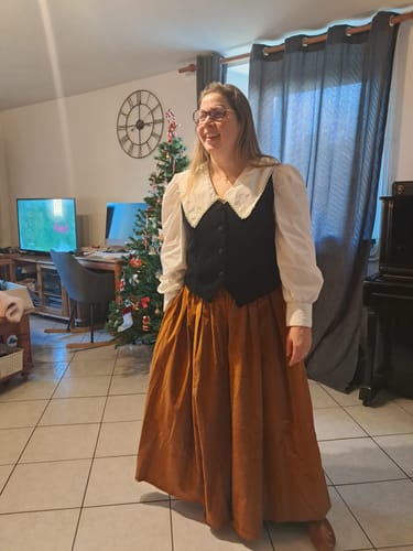Une cliente porte le pantalon Paco en velours écureuil. La coupe très ample du pantalon donne l'illusion d'une jupe longue.