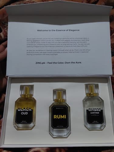 Reviewer's open Winter Box showing the three perfume bottles: Black Oud, Rumi, and Ombre Leather.