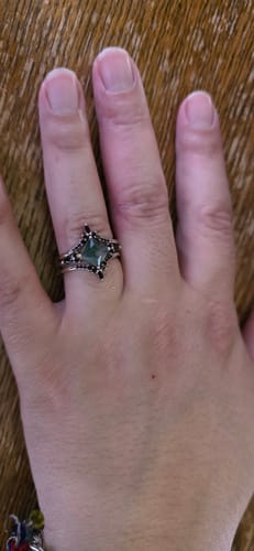 Customer's hand wearing the Mirael three-band ring set stacked on one finger.