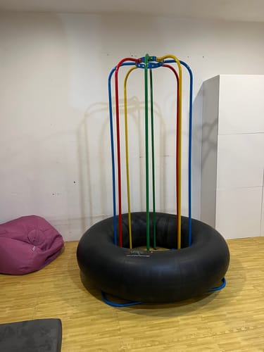 Customer's Jungle Jumparoo with colorful poles set up indoors in a playroom.