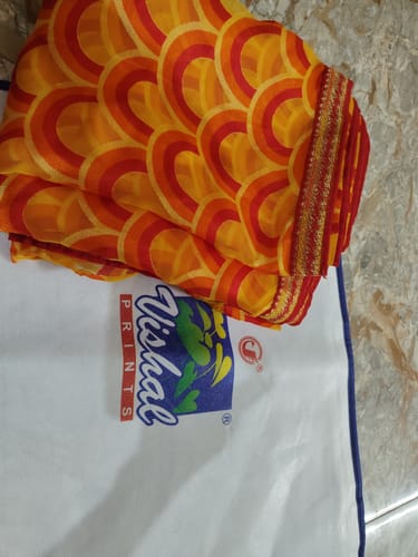 Customer photo review of Vishal Prints Carrot Orange And Persian Red Printed Chiffon-Brasso Saree With Zari Border