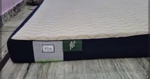 Customer's Flo Anti-Gravity™ Mattress on a floor, showing the white textured top cover and dark blue side with the brand logo.
