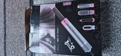 Reviewer's photo of the black and pink box for the 5 in 1 MultiStyler Pro lying on a carpet.