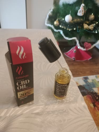Reviewer's photo of a small dropper bottle and its packaging on a table.