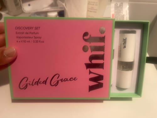 Customer showing the discovery set box containing their Lychee Blush perfume.