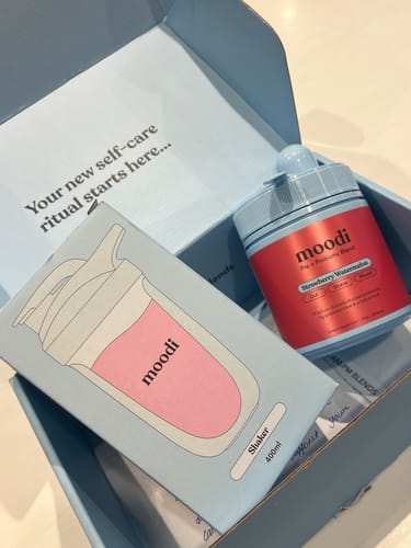 Customer's Strawberry Watermelon container and a shaker box inside an open blue delivery box.