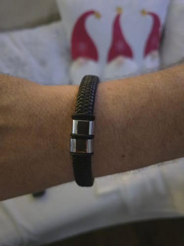 Customer's wrist showing the black braided Viking bracelet and its silver-tone clasp.