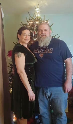 Reviewer wears the green velvet V-neck dress for a Christmas party, showing the fit and side button detail.