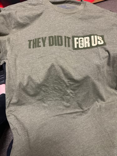 Customer's green T.V.P. Elite Membership t-shirt with the text 'THEY DID IT FOR US' and a soldier silhouette.