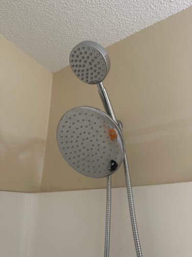 Customer's installed 1-Spray Dual Shower Head Set, showing the chrome rain and handheld shower heads.