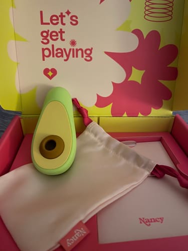 Customer's green Avo Clitoral Massager shown in its colorful packaging with a white storage pouch.