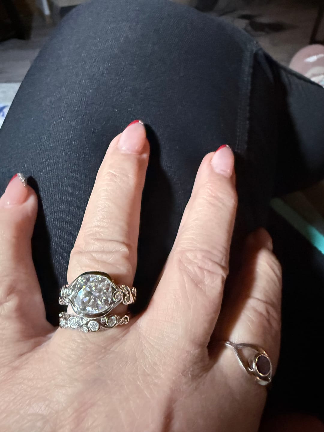 Customer photo review of Bezel Set Round Moissanite Scroll Accents Wedding Band Ring In Sterling Silver