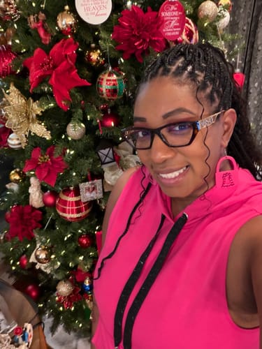 Reviewer smiling, showing off her long braided hairstyle using Spanish Curl Bulk Hair Extensions.