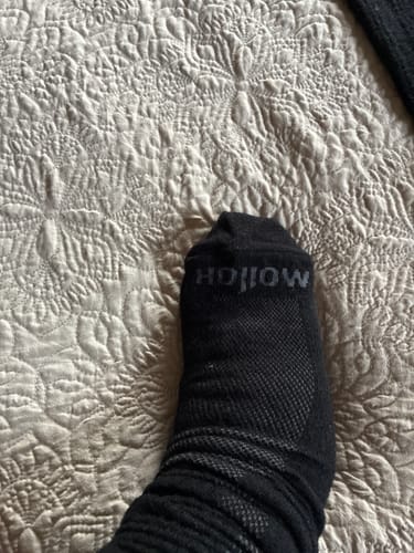Close-up of a reviewer's foot wearing the black Performance Eucalyptus Compression Socks.