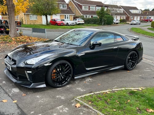 Customer's black sports car with a deep, glossy shine after being treated with Elixir Polymer Sealant.