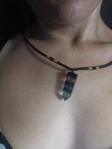 Close-up of a reviewer wearing the Natural Fluorite Necklace, showing the colorful crystal pendant.