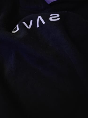 Customer's close-up of the white 'SAVD' logo on the back of their black SAVD Oversized Hoodie.