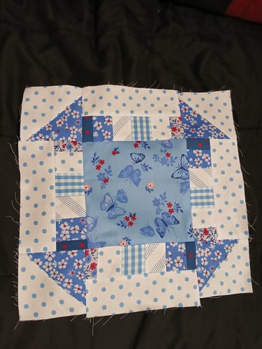 Customer's completed quilt block from the Mrs Quilty Subscription Box, showing patterned blue and white fabrics.