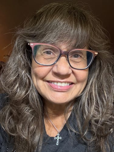 Close-up of a reviewer smiling, showing smoother-looking skin after using F-Balm Tallow Balm.