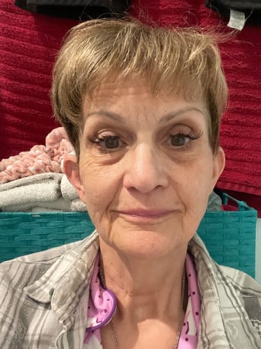 Reviewer smiling while wearing full, natural-looking Amplify Core Gossamer® Lashes.