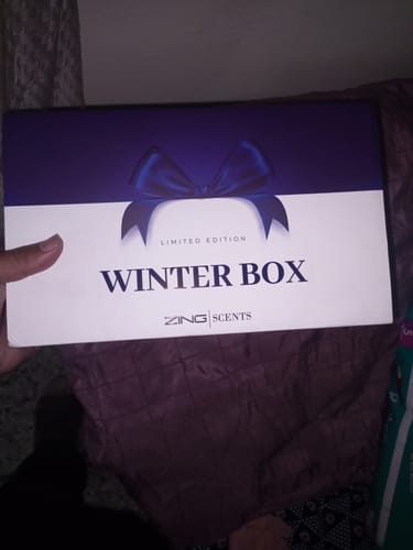 A customer holds the blue and white packaging for the limited edition Winter Box.