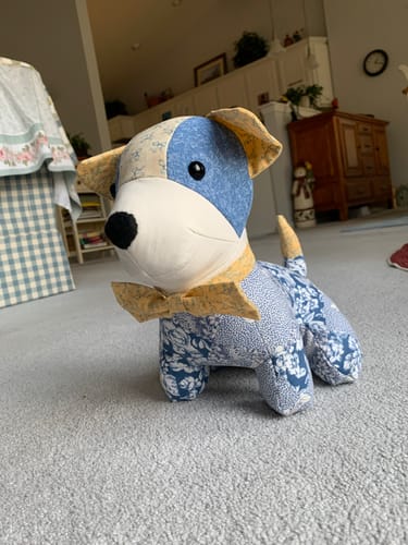 Customer's completed Benny the Puppy toy made with blue and yellow patterned fabric, with a matching bow tie.