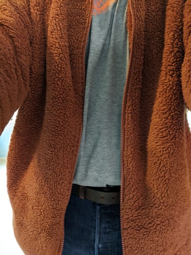 Reviewer wearing The Rockford Braided Bison belt with jeans and an open fleece jacket.