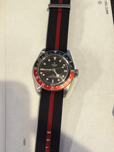 Customer's Ribbed Single-Pass - Black & Red strap shown on a watch with a black dial and two-tone bezel.