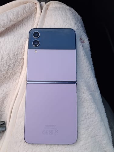Reviewer's purple Samsung Galaxy Z Flip4 unfolded, showing the back of the phone and dual camera.