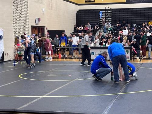 Customer's view of a wrestling tournament, where the Christian Performance Socks are worn.