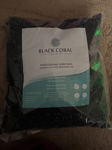 Customer's large, clear bag of Black Coral Hard Wax beads, sitting on a surface.