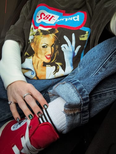 Customer wearing the pear-cut Pia Ring on their pinky finger, styled with a casual outfit.