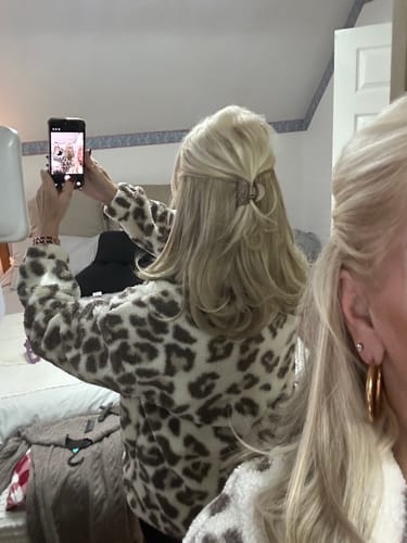 Reviewer's back view, showing the Flicky Clip-in Hair Extension styled in a blonde, half-up hairstyle.